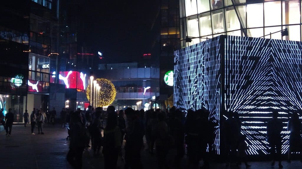 Sanlitun Village at night. On the right a large cube that is a light show. This place is almost always packed with people. Plenty of shops with names you all know.